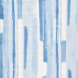 Watercolor blue abstract stripe wallpaper by Schumacher, styled in a modern interior setting.