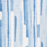Watercolor blue abstract stripe wallpaper by Schumacher, styled in a modern interior setting.