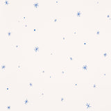 Calisto wallpaper in Ivory & Cobalt by Schumacher, featuring a playful scattered star motif in blue on an ivory background.