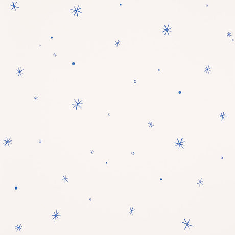 Calisto wallpaper in Ivory & Cobalt by Schumacher, featuring a playful scattered star motif in blue on an ivory background.
