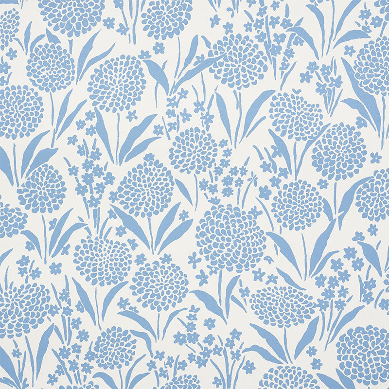 Chrysanthemum Chambray blue floral wallpaper by Schumacher, shown in close-up and installed in a bedroom setting.