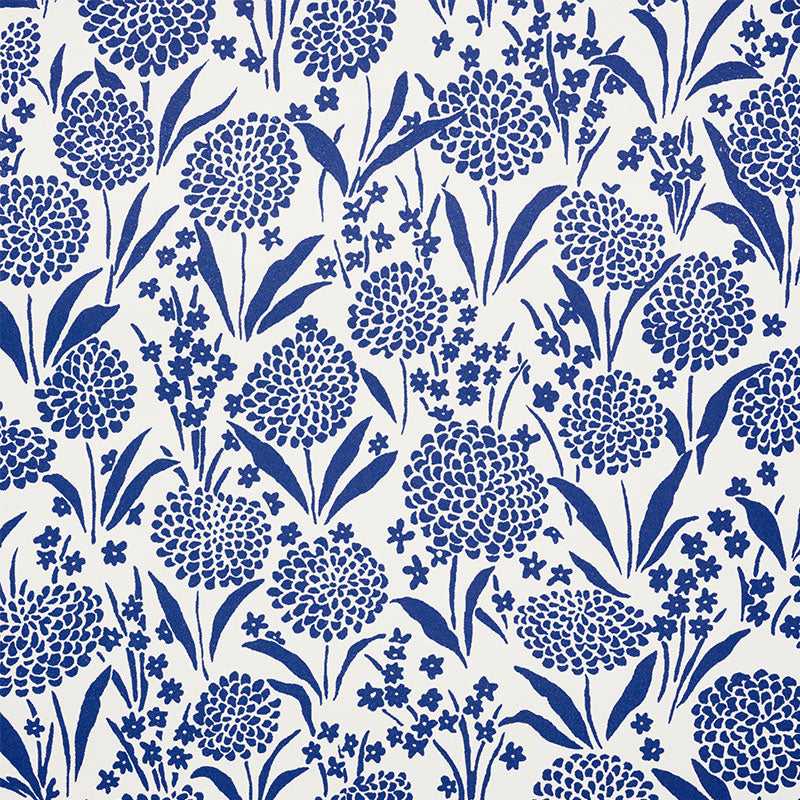 Chrysanthemum blue floral small-print wallpaper by Schumacher shown in detail and installed in a bedroom setting.