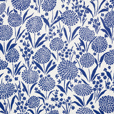 Chrysanthemum blue floral small-print wallpaper by Schumacher shown in detail and installed in a bedroom setting.