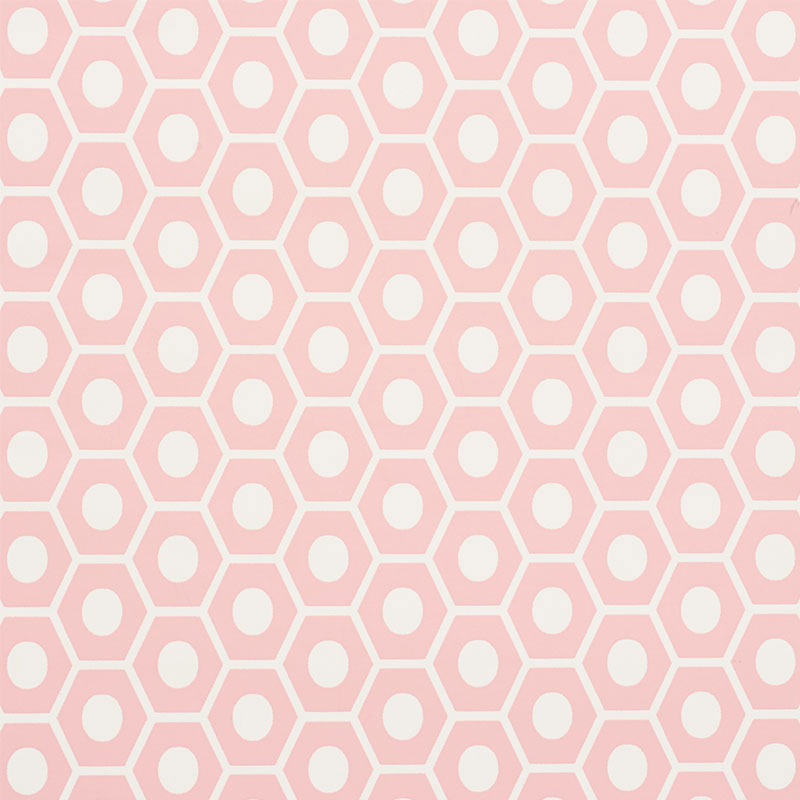 QUEEN B geometric pink and white hexagon wallpaper by Schumacher, shown in a styled interior and close-up pattern view.