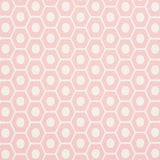 QUEEN B geometric pink and white hexagon wallpaper by Schumacher, shown in a styled interior and close-up pattern view.