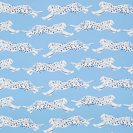 Leaping Leopards wallpaper in Sky by Schumacher features rows of sleek, spotted leopards on a blue background, perfect for adding a lively, chic touch to any room.