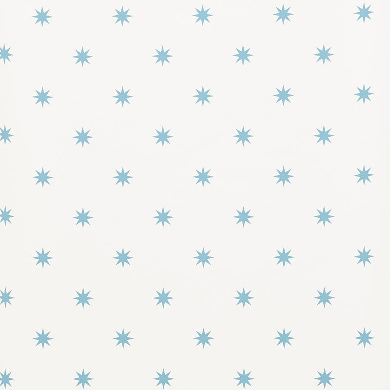Stargaze blue star pattern wallpaper by Schumacher shown in a bedroom and study setting