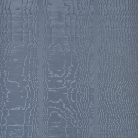 Moire Ocean wallcovering by Schumacher shown in a room setting with a dog on a chair, featuring a watery, irregular blue pattern.