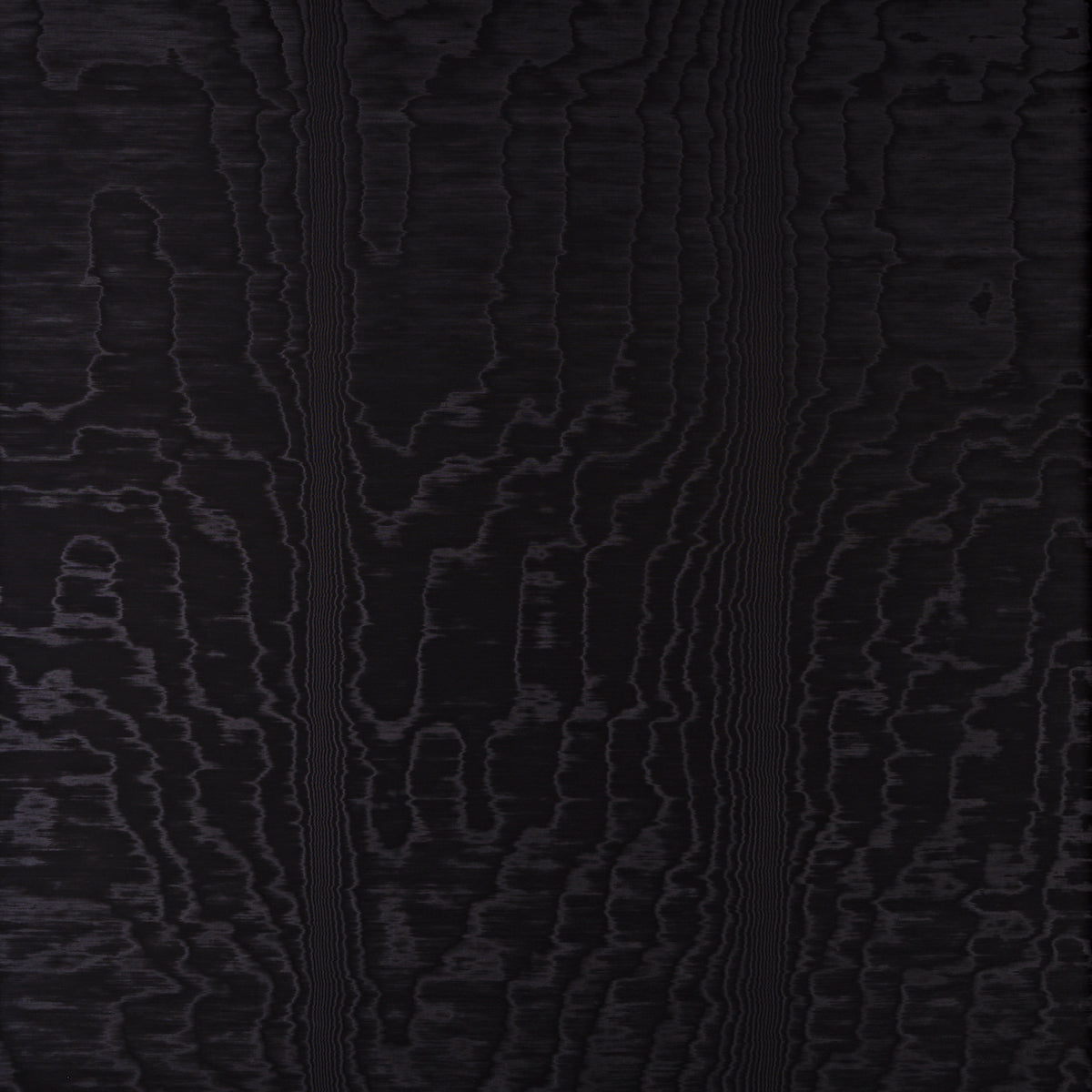 Moire Noir wallcovering with a watery, irregular moiré pattern and delicate faille weave, shown in a modern interior setting.