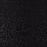 Moire Noir wallcovering with a watery, irregular moiré pattern and delicate faille weave, shown in a modern interior setting.