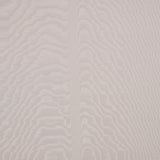 Moire wallcovering in Dove by Schumacher, featuring a watery, irregular moiré pattern with a delicate faille weave in a soft neutral shade, installed in a modern bedroom.