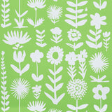 Wild Things wallpaper in Leaf by Vera Neumann for Schumacher, featuring stylized white flowers on a vibrant green background.
