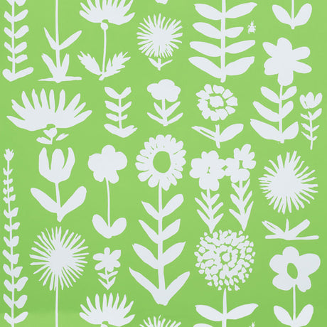 Wild Things wallpaper in Leaf by Vera Neumann for Schumacher, featuring stylized white flowers on a vibrant green background.