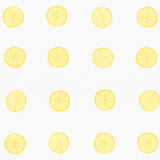Lemonade wallpaper by Vera Neumann for Schumacher featuring whimsical hand-drawn lemon slices in a polka dot pattern on a white background.