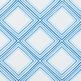 Square Dance by Vera Neumann for Schumacher. Blue geometric concentric diamond wallpaper pattern, shown in a modern interior setting.