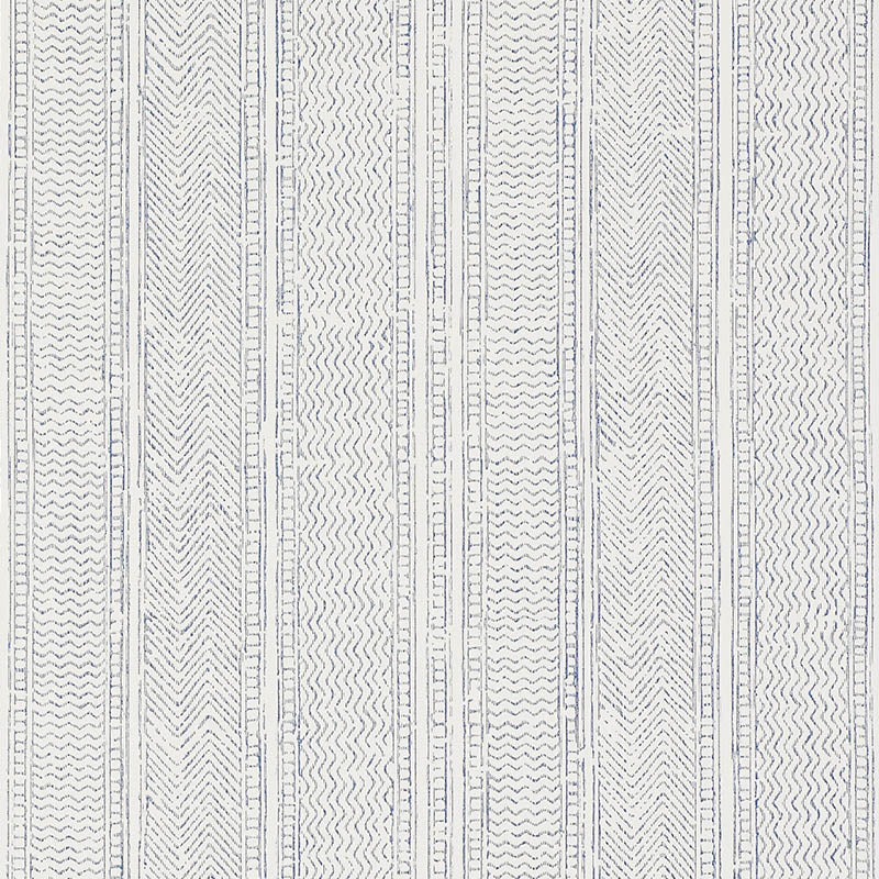 Mohave Indigo by Schumacher - Artisanal handblocked stripe wallpaper in blue and white, shown in a modern bedroom setting.