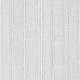 Mohave Indigo by Schumacher - Artisanal handblocked stripe wallpaper in blue and white, shown in a modern bedroom setting.