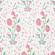 Khilana Floral wallpaper in pink with stylized Indian-inspired floral motifs by Schumacher, shown in a bedroom setting.