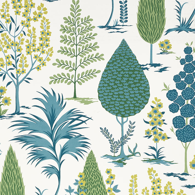 Pandora Peacock wallpaper by Schumacher features a whimsical grove of stylized trees in blue, green, and yellow on a white background.