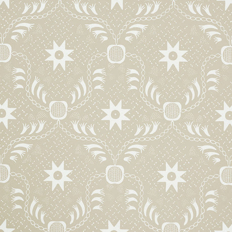 Lancaster Sand by Schumacher - geometric star and chain pattern wallpaper in beige and white, styled in a modern living room.