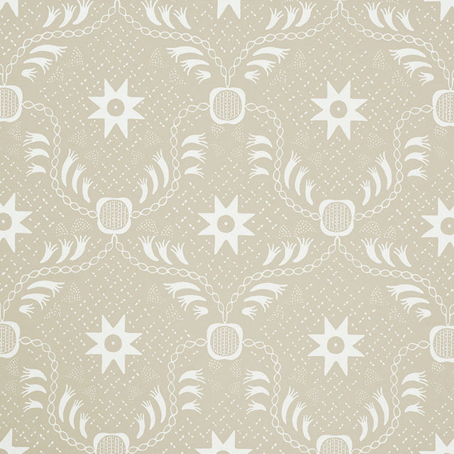 Lancaster Sand by Schumacher - geometric star and chain pattern wallpaper in beige and white, styled in a modern living room.
