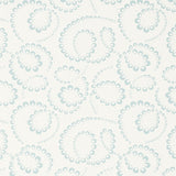 DORIAN wallpaper in Sky by Schumacher features abstracted botanical swirls in a soft blue on white background, shown in a modern bedroom setting.
