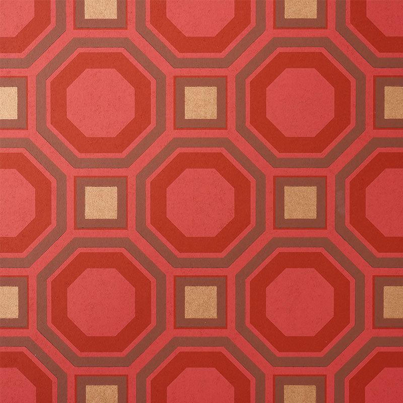 HANOVER Ruby geometric lattice wallpaper by Schumacher, bold red and gold octagonal and square pattern, surface-printed for rich depth.