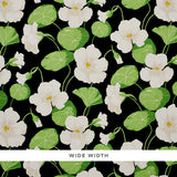 Nasturtium Noir floral wallpaper with large white flowers and green leaves on a black background by Schumacher