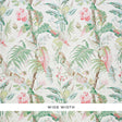 Tropique Blush by Schumacher - painterly tropical botanical wallpaper with interwoven blossoms, leaves, and branches in blush and green.