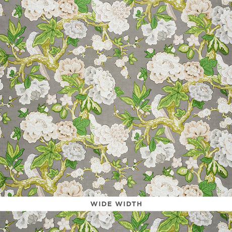 Bermuda Blossoms wallpaper in Slate by Schumacher, featuring a bold floral pattern with green leaves and white blossoms on a grey background.