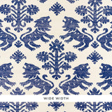 Regalia Sisal wallpaper in blue, featuring mirrored lions and stylized flowers on a textured grasscloth background.