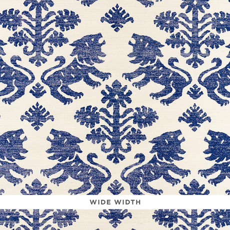 Regalia Sisal wallpaper in blue, featuring mirrored lions and stylized flowers on a textured grasscloth background.