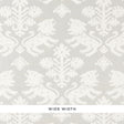Regalia Sisal wallpaper in ivory on silver, featuring mirrored lions and stylized flowers on textured grasscloth by Schumacher.