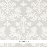 Regalia Sisal wallpaper in ivory on silver, featuring mirrored lions and stylized flowers on textured grasscloth by Schumacher.