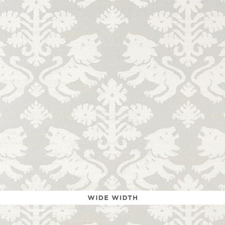 Regalia Sisal wallpaper in ivory on silver, featuring mirrored lions and stylized flowers on textured grasscloth by Schumacher.