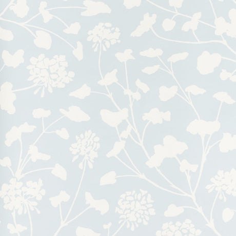 Pennick Sky painterly floral wallpaper by Schumacher in a crisp white silhouette on a soft blue background, styled in a modern interior.