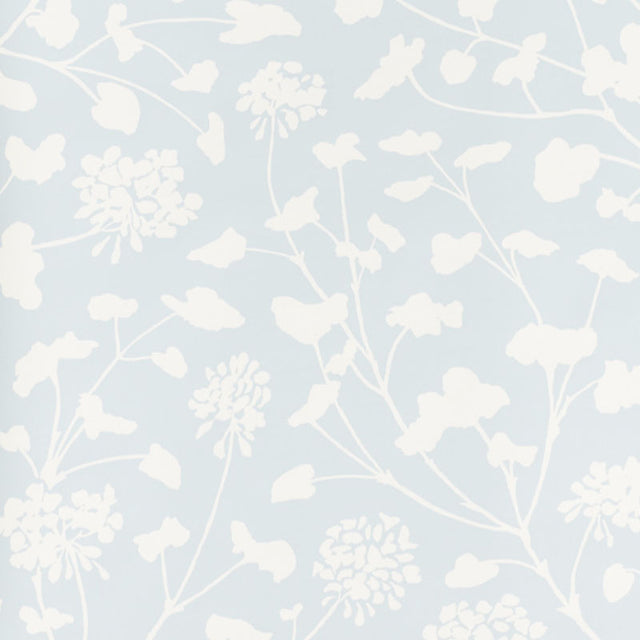 Pennick Sky painterly floral wallpaper by Schumacher in a crisp white silhouette on a soft blue background, styled in a modern interior.