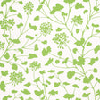 Pennick Leaf on Ivory wallpaper by Schumacher features a painterly green floral silhouette on an ivory background, shown in a bright, airy bathroom setting.