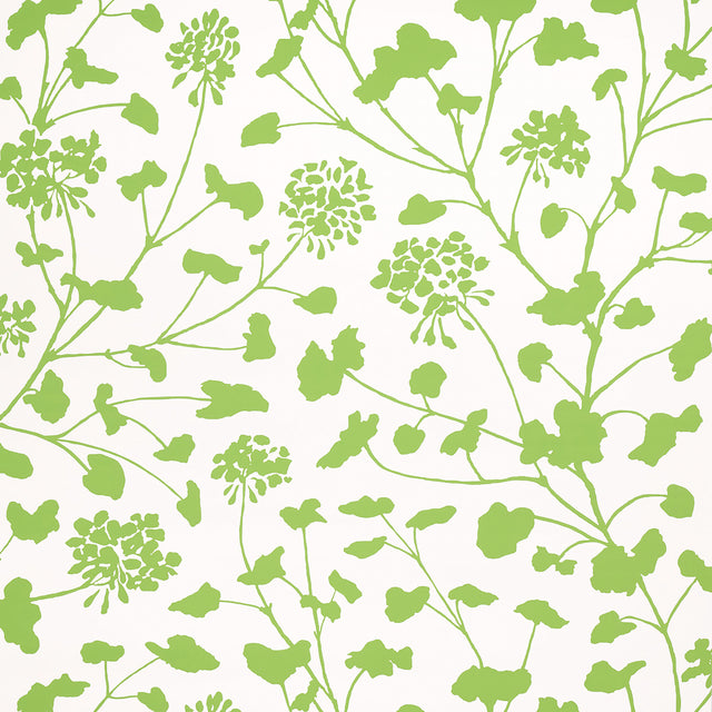 Pennick Leaf on Ivory wallpaper by Schumacher features a painterly green floral silhouette on an ivory background, shown in a bright, airy bathroom setting.