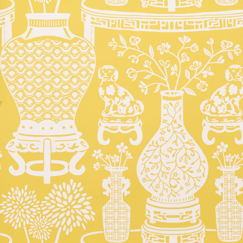 Yellow chinoiserie wallpaper featuring Ming vases, Staffordshire dogs, and floral motifs in a mirrored repeat by Schumacher.
