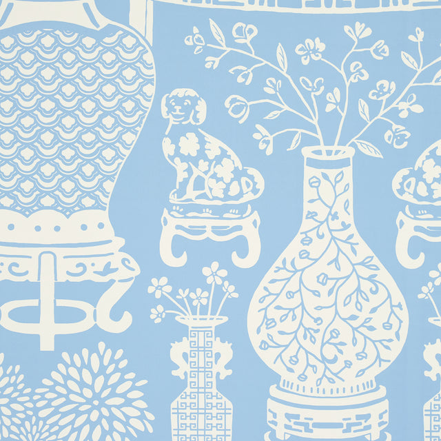 Hellene wallpaper in Sky by Schumacher featuring Ming vases and Staffordshire dogs in a mirrored pattern on a blue background.