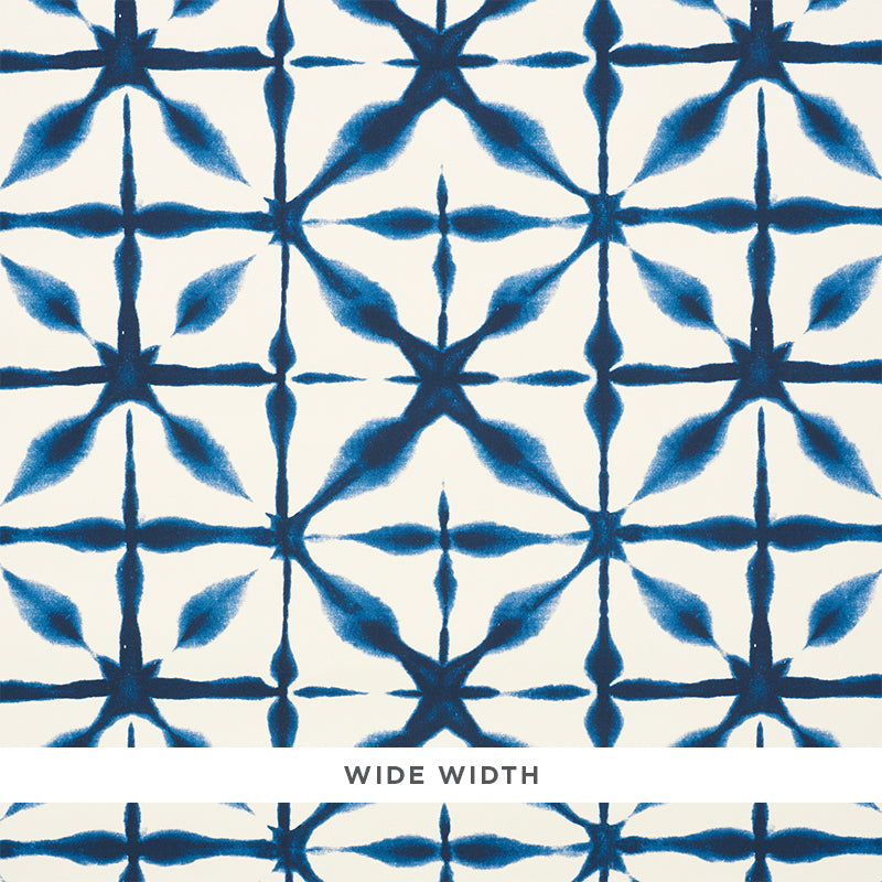 Andromeda blue shibori-inspired geometric wallpaper by Schumacher shown in close-up and installed in a kitchen interior.