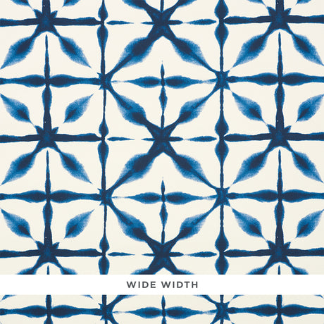 Andromeda blue shibori-inspired geometric wallpaper by Schumacher shown in close-up and installed in a kitchen interior.