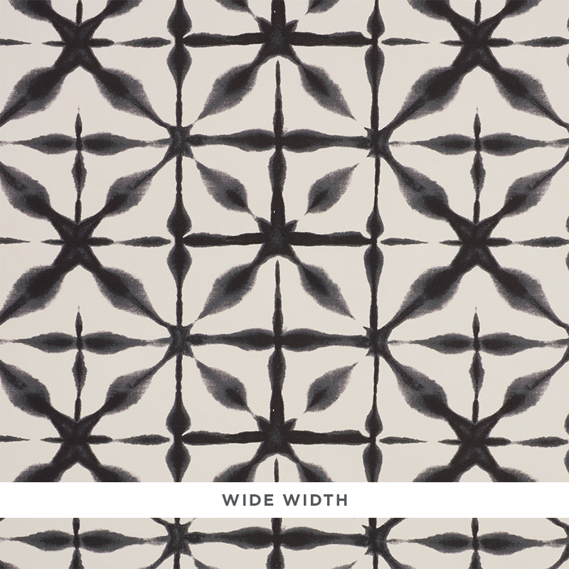 Andromeda Charcoal by Schumacher, a wide-width wallpaper with a shibori-inspired geometric pattern in black and white.