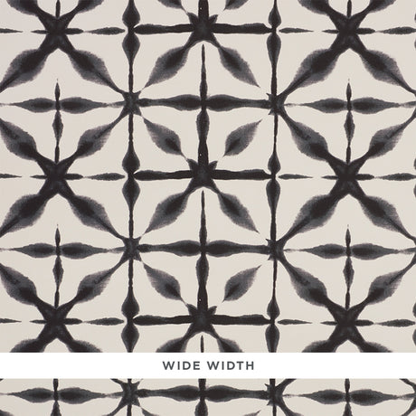 Andromeda Charcoal by Schumacher, a wide-width wallpaper with a shibori-inspired geometric pattern in black and white.