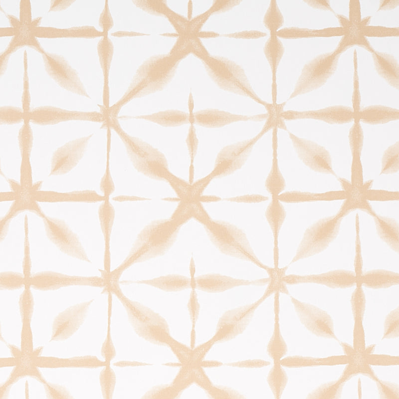 ANDROMEDA wallpaper in Sand by Schumacher, a shibori-inspired geometric pattern in soft beige tones, shown in a modern interior setting.