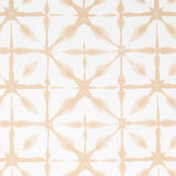 ANDROMEDA wallpaper in Sand by Schumacher, a shibori-inspired geometric pattern in soft beige tones, shown in a modern interior setting.