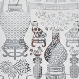 HELLENE MYLAR wallpaper features a preppy chinoiserie design with Ming vases and Staffordshire dogs in a mirrored silver pattern by Schumacher.