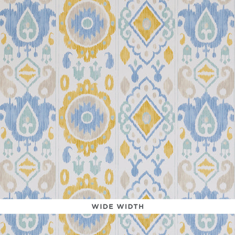 ELIZIA IKAT wallpaper in sky and ochre, a wide-width wallcovering with a delicate ikat pattern in blue, yellow, and beige tones.