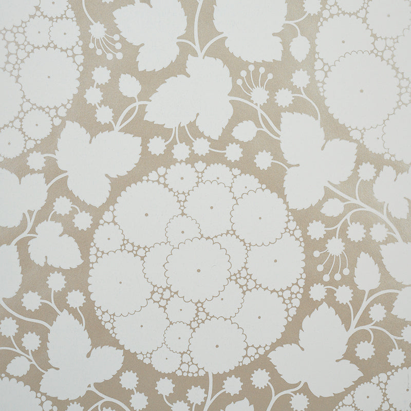 Marianne Champagne by Schumacher - Pop Art floral wallpaper in champagne and white, shown in detail and styled in a bedroom setting.